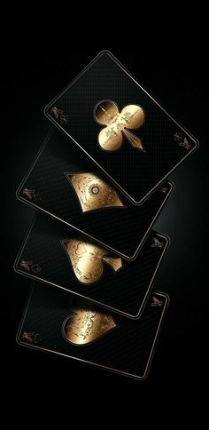 three black and gold business cards on a dark background