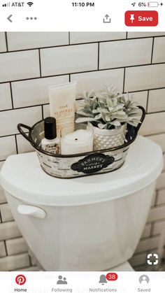 a white toilet sitting in a bathroom next to a tiled wall