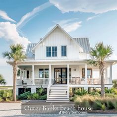 a white house with palm trees in front of it and the words outer banks beach house