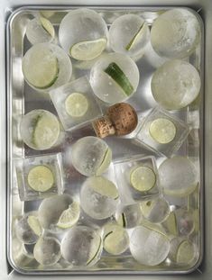 ice cubes with lime slices and a bottle of wine sitting on top of them