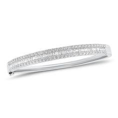 You simply can’t go wrong with a diamond bangle. This elaborate bracelet features 70 round diamonds and 51 slim baguettes. Slip it on your wrist for an instant confidence boost. - 18K gold weighing 20.68 grams - 70 round diamonds weighing 1.12 carats - 51 slim baguettes weighing 0.98 carats - Color - F-G - Clarity - VS2-SI1 Available in yellow, white, and rose gold. Please allow 4-6 weeks for delivery if item is not in stock. Item no. BR01299 Elegant Bangle With Baguette Cut Diamonds, Formal Baguette Diamond Bangle Bracelet, Timeless Diamond-accented Baguette-cut Bracelets, Luxury Baguette-shaped Elegant Bracelet, Luxury Baguette-cut Diamond Bracelet With 17 Jewels, Diamond Huggie Earrings, Gold Ear Cuff, Diamond Bangles Bracelet, Fringe Necklace