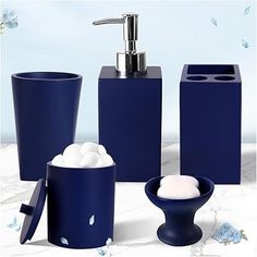 blue bathroom accessories including soap dispenser, toothbrush holder and tissue dispenser