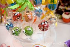 there are many lollipops that have faces on them and bows around them