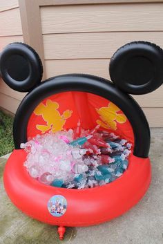 an inflatable mickey mouse float filled with ice and plastic water toys for kids