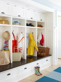 an image of a room with many coats on the shelves