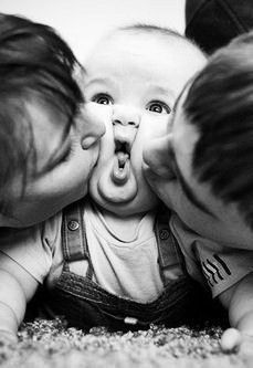 two adults and a baby making faces with their mouths open