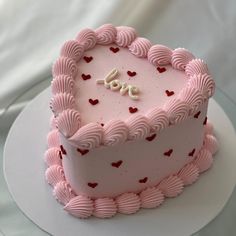 a heart shaped cake with the word love written on it