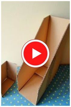 an open cardboard box sitting on top of a blue polka dot tablecloth covered floor