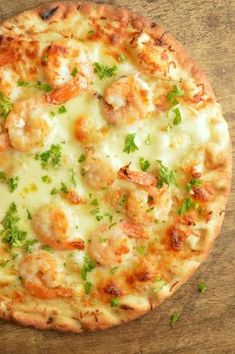 a pizza sitting on top of a wooden table