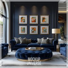 a living room with blue couches and pictures on the wall above them, along with a round coffee table