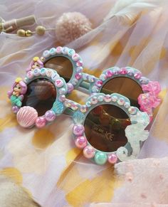 two children's sunglasses with little mermaid decorations on them