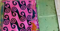 a pink and black painting on the ground next to a tile floor with green tiles