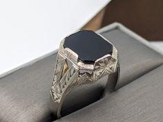 14k Solid White Gold Onyx Signet Ring Beautiful etched design It's a huge and heavy statement ring The bold and eye-catching vintage ring has a striking midnight  black onyx. It has a beautiful handcrafted design and is one of a kind.  Hallmarked 14k Gold has been verified.  Size 9 1/2 RESIZABLE  Weight 6.9 grams 3.9 mm band width 15.0 mm wide Gemstones: Onyx 13mm x 10mm All our jewelry is adequately washed and disinfected to ensure customers get clean items with every order. Comes in a beautiful gift 🎁 box Luxury Onyx Signet Ring For Anniversaries, Signet Wedding Ring, Onyx Signet Ring, Etched Designs, Etsy Wedding Rings, Black Onyx Ring, Black White Gold, Ring Black, Onyx Ring