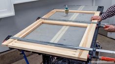 a man is working on an unfinished piece of wood that he has made into a table