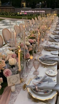 the table is set for a formal dinner with candles and flowers in vases on it