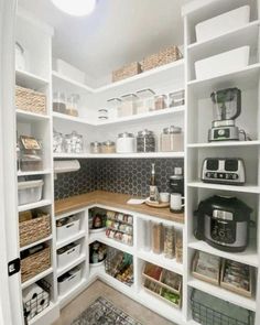 an organized pantry with white shelves and baskets