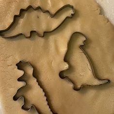 three cookie cutters shaped like trees on top of each other in the shape of cookies