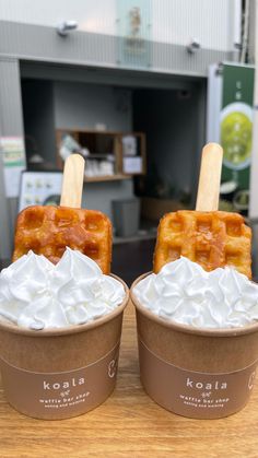 two waffles with whipped cream and caramel on top sit next to each other