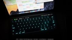 a laptop computer sitting on top of a desk next to a monitor with keyboard keys