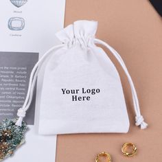 a bag with two gold rings next to it