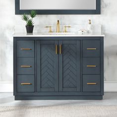 a bathroom vanity with two sinks and a mirror on the wall above it, along with a potted plant