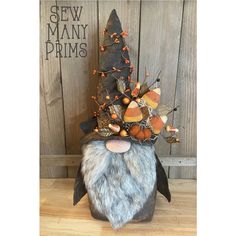 a gnome's head is adorned with autumn decorations