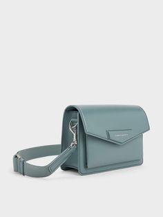 Featuring a sleek envelope-style construction and a beautiful slate-blue finish, this Adelie bag is perfect for those who love a structured bag in an eye-catching colour. It opens up to a compact interior that will hold all your daily essentials with ease -- the magnetic closure ensure easy access. This bag comes with a thick shoulder strap that offers good weight distribution, which can be easily adjusted to your preferred drop length. Structured Bag, Shell Station, Bag Dark, Charles Keith, Everyday Bag, Slate Blue, Eye Catching Colors, Magnetic Closure, Old World