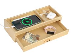 an open drawer with money, keys and other items in it that include a phone