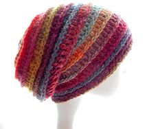 a multicolored knitted hat is shown on a mannequin's head