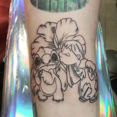 a person with a tattoo on their arm has a koala bear and lillies