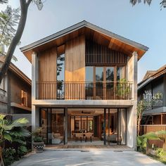 a large house with two levels and wooden balconies on the second floor is surrounded by greenery