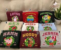 six christmas pillows on a couch with the names and numbers printed on them, all in different colors