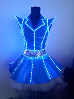 a dress made out of plastic with blue light up lights on it and white tulle skirt