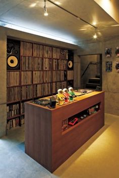 a record player's desk in the middle of a room filled with books and records