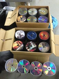 two boxes filled with cds sitting next to each other