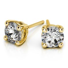 These classic round cut diamond stud earrings are held in a yellow gold four-prong setting. Each G-H color, SI1 clarity, Excellent cut diamond weighs 1/8 carat, for a total diamond weight of 1/4 carat. Proudly made in the USA. Round Diamond Stud Earrings, Diamond Solitaire Earrings, Diamond Earrings Studs Round, Gold Diamond Earrings Studs, Solitaire Earrings, Moissanite Earrings, Gold Diamond Earrings, Men Diamond Ring, Diamond Stud Earrings