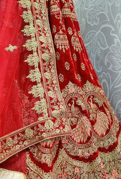 Heavy Designer Wedding Wear Lehenga Choli. FABRIC: Velvet DUPATTA: Soft Net COLOR: Red WORK: Heavy Thread Embroidered Work Bonus offer - Receive a free mystery gift with your order. Stitching Option - We will email you the measurement guide to confirm your size. SHIPPING: The product will be shipped within 1 - 2 weeks from the date of purchase. Product is returnable if un-Stitched This product qualifies for free shipping For any Rush/Urgent orders please email us at customercare@desiroyale.com W Traditional Marriage Sets With Intricate Embroidery, Embroidered Marriage Sets With Traditional Drape, Embroidered Sets With Traditional Drape For Marriage, Embroidered Sets For Marriage With Traditional Drape, Embroidered Wedding Sets With Traditional Drape, Embroidered Festive Marriage Sets, Ceremonial Red Sets With Intricate Embroidery, Red Embroidered Ceremony Sets, Red Ceremony Sets With Intricate Embroidery