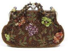 "Vintage Brown Clutch Chain Purse Bag with Earthtone Beads and Natural Stones Embrace a touch of nature with this vintage brown clutch chain purse adorned with earthy beads and natural stones. The intricate design features green bead leaves on a dark brown bead background, complemented by clusters of natural pink, purple, and jade-colored stones gracing both sides. The strap, crafted with hundreds of tiny earthtone stones, adds a unique, artisanal touch. Measuring approximately 8\" wide x 5.5' h Elegant Brown Beaded Evening Bag, Handmade Brown Clutch Evening Bag, Vintage Brown Pouch Evening Bag, Handmade Brown Evening Clutch, Handmade Brown Rectangular Evening Bag, Brown Pouch Evening Bag As Gift, Elegant Handmade Brown Clutch, Elegant Handmade Brown Evening Bag, Vintage Brown Evening Bag As Gift