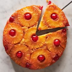 a pineapple upside down cake with cherries on the top and one slice missing