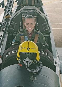 a woman sitting in the cockpit of an airplane