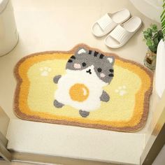 a bathroom rug with a raccoon holding an egg on it's side