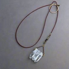 This 3 Point Quartz Lariat Talisman Necklace Is An Original Design By Marie At Blackbird & Sage Exclusively For Her Studio Athene Noctua Jewelry Line. Handmade In Santa Fe, Nm. Features Made To Order Boho Style Lariat Talisman Necklace 3 Large Quartz Crystal Points Pendant With Chain 2.75 Inches (6.6 Cm) Long, 1.5 Inches (3.8 Cm) Wide Featuring Brass Wire, Brass Beads, Brass Circle With Antique Brass Rolo Chain 2mm Red/Brown Untreated Natural Leather The Stone Quartz - All Chakras Raises Energy Long Copper Necklace, Wire Beads, Brass Circle, Long Necklace Boho, Mystical Jewelry, Talisman Necklace, Quartz Crystal Pendant, Quartz Crystal Necklace, Santa Fe Nm