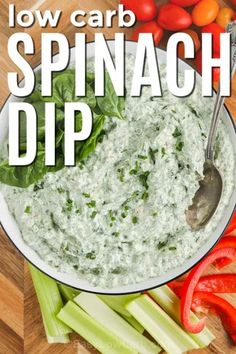 spinach dip in a bowl with celery and red peppers on the side