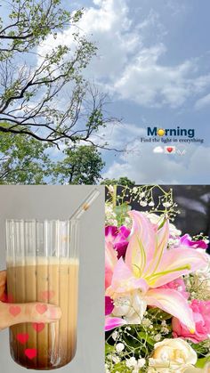 a person holding a glass with liquid in it next to pictures of flowers and trees