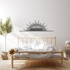 a bed sitting in a bedroom next to a plant