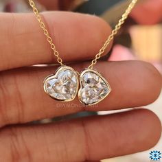 Handcrafted Elegance for Every Day: Dive into the world of bespoke jewelry with our Twin Stone Heart Shaped Pendant, meticulously handcrafted for the modern woman. Whether it's a day at the office or a night on the town, this piece is your new go-to. Moissanite Magic: Delight in the dazzling sparkle of 4-carat moissanite. Set in a sophisticated bezel, this pendant promises brilliance that mirrors diamonds. 14kt Yellow Gold Luxe: Immerse yourself in the timeless allure of 14kt yellow gold. It's n Luxury Bezel-set Heart Cut Jewelry, Luxury Bezel Set Jewelry For Valentine's Day, Luxury Jewelry With Bezel Setting For Valentine's Day, Luxury Heart Cut Bezel Set Jewelry, Luxury Heart-shaped Jewelry With Bezel Setting, Classic Heart Cut Jewelry With Bezel Setting, Gia Certified Yellow Gold Necklace For Anniversary, Fine Jewelry Gia Certified Heart-shaped, Gia Certified 14k Gold Jewelry For Anniversary