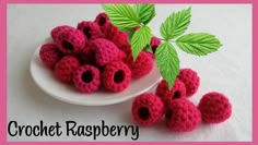 crochet raspberry on a plate with leaves