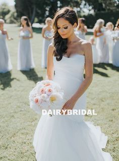 a woman in a white dress holding a bouquet