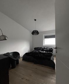 a black and white photo of a bedroom