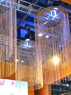 three chandeliers hanging from the ceiling in a building